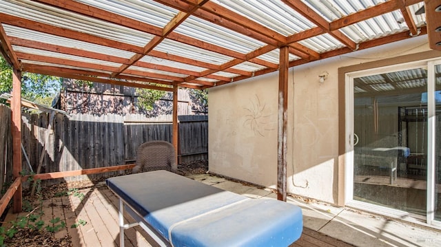 wooden deck with a pergola and a patio area