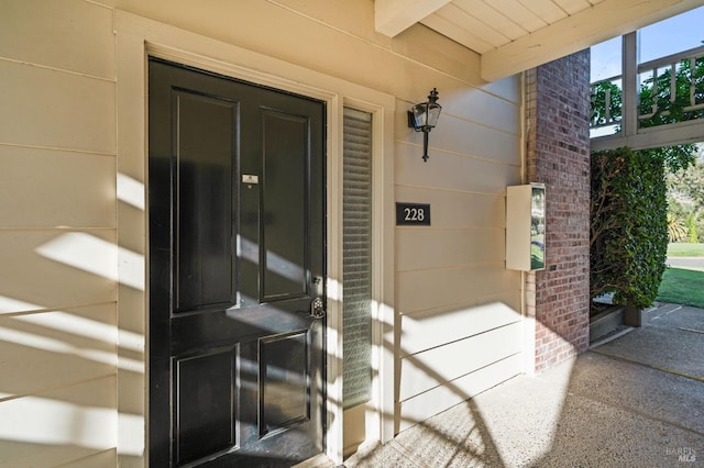 property entrance featuring brick siding