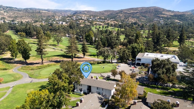 bird's eye view with view of golf course and a mountain view