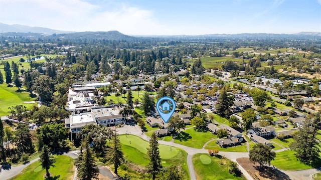 drone / aerial view with a mountain view and golf course view