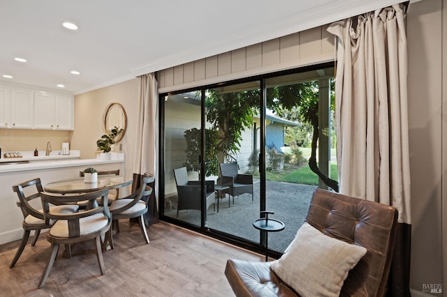 interior space with recessed lighting, light wood-type flooring, and crown molding