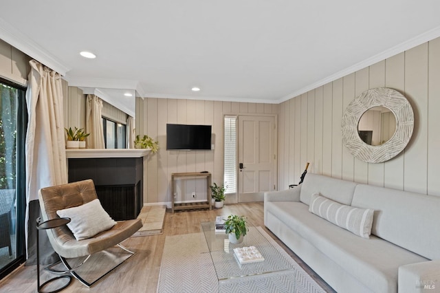 living area featuring ornamental molding, wood finished floors, and recessed lighting