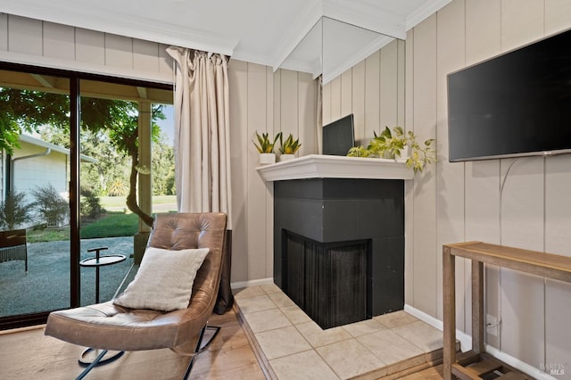 sitting room featuring ornamental molding, a fireplace, and tile patterned floors