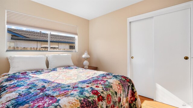 bedroom featuring light wood-type flooring and a closet