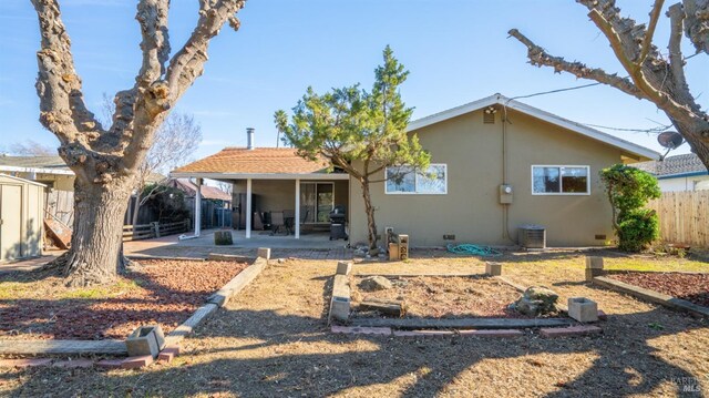 rear view of property featuring central AC and a patio