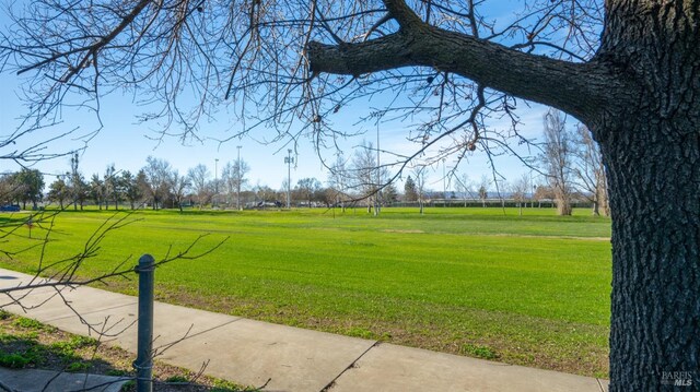 view of property's community with a lawn