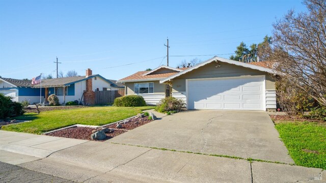 ranch-style house featuring a garage and a front lawn