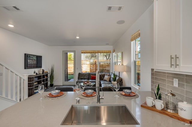 kitchen featuring white cabinets and decorative backsplash