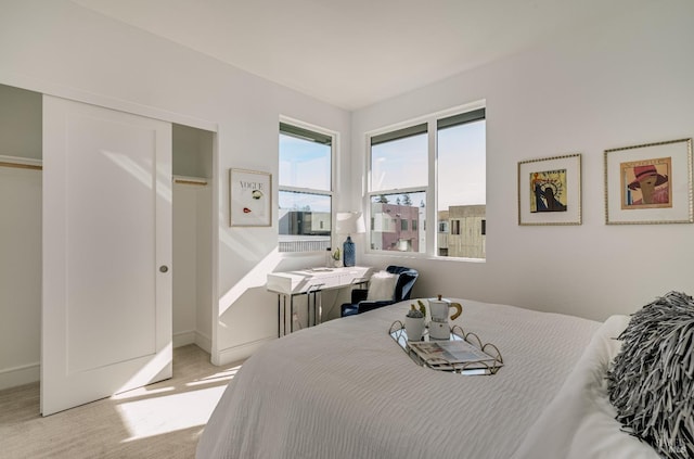 bedroom featuring light carpet and a closet