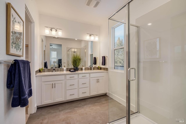 bathroom featuring vanity and a shower with shower door