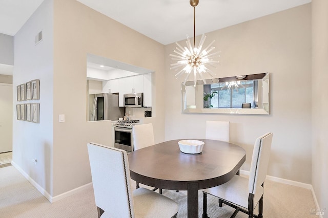 carpeted dining area with a chandelier