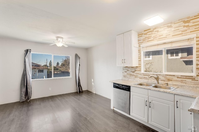 kitchen with dark wood-style flooring, backsplash, white cabinets, a sink, and dishwasher