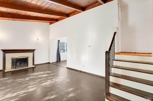 unfurnished living room with beam ceiling, wood ceiling, and a fireplace