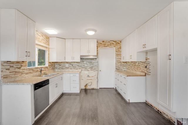 kitchen featuring backsplash, stainless steel dishwasher, dark wood-type flooring, a sink, and under cabinet range hood