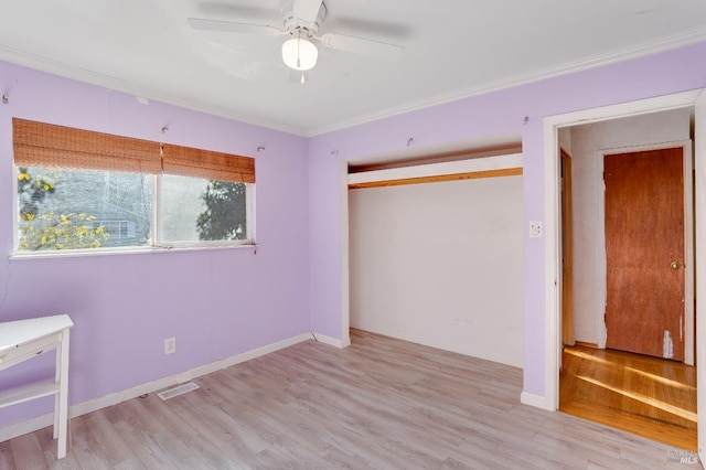 unfurnished bedroom with ornamental molding, wood finished floors, visible vents, and baseboards