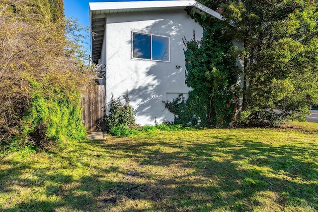 view of home's exterior featuring a yard and stucco siding