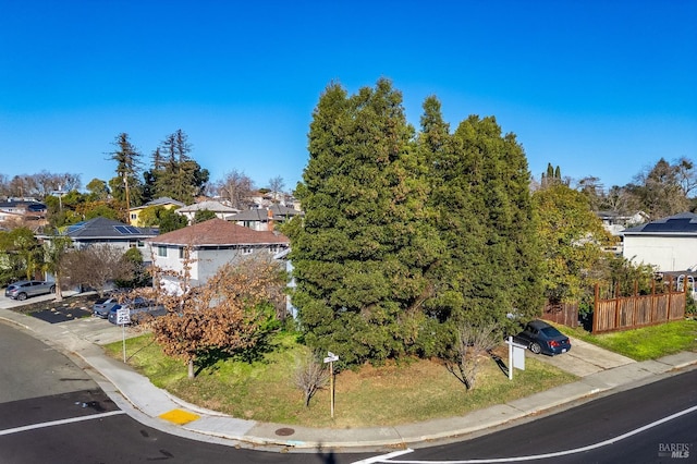 view of front of home with fence and a residential view