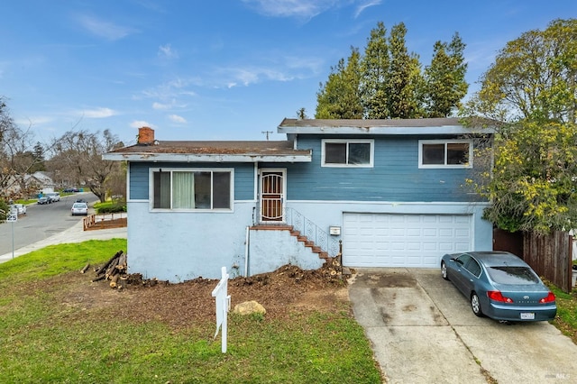 tri-level home with concrete driveway, an attached garage, and stucco siding