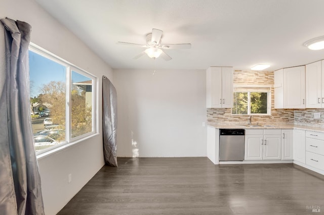 kitchen featuring dark wood-style floors, light stone counters, decorative backsplash, white cabinets, and dishwasher