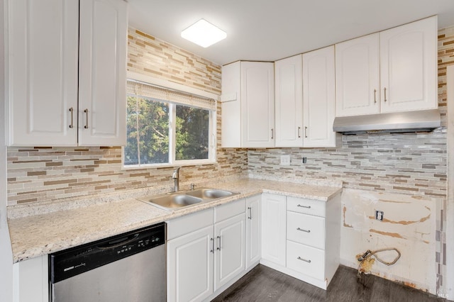 kitchen featuring stainless steel dishwasher, a sink, white cabinets, and tasteful backsplash