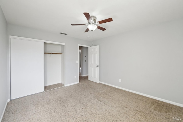 unfurnished bedroom featuring ceiling fan, carpet flooring, visible vents, baseboards, and a closet