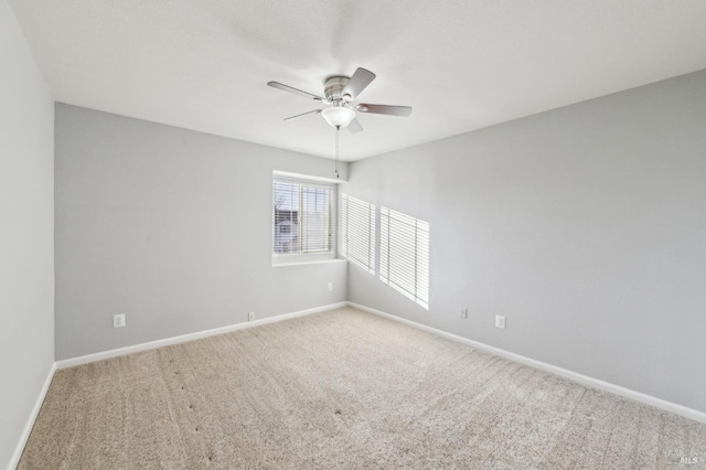 unfurnished room featuring carpet flooring, a ceiling fan, and baseboards