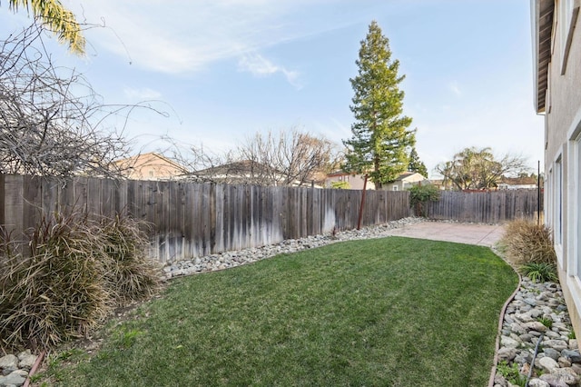 view of yard with a fenced backyard and a patio