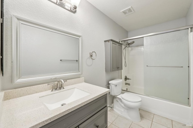 full bathroom featuring shower / washtub combination, visible vents, toilet, vanity, and tile patterned floors