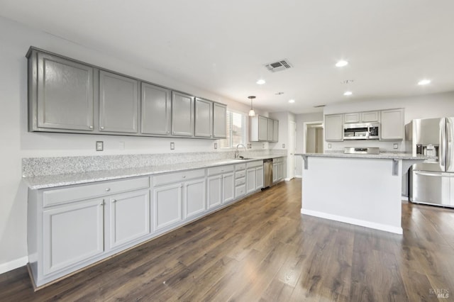 kitchen with visible vents, appliances with stainless steel finishes, gray cabinets, and dark wood finished floors