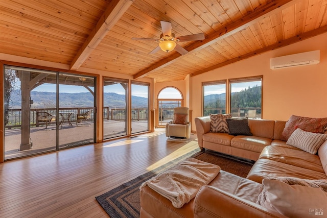 living room with a wall unit AC, vaulted ceiling with beams, a mountain view, and wooden ceiling