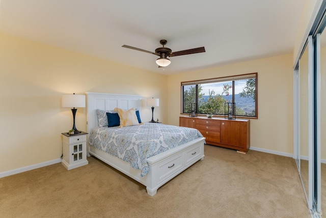 carpeted bedroom featuring a closet and ceiling fan