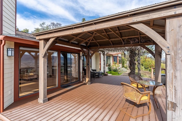 wooden terrace featuring a gazebo