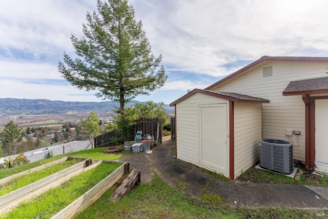 view of outbuilding featuring a mountain view and central air condition unit