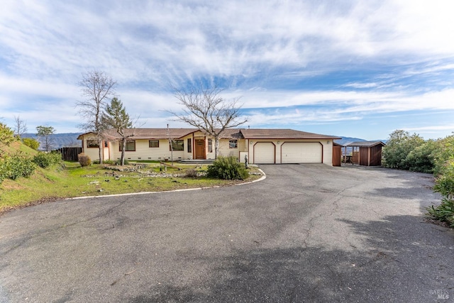 ranch-style house with a garage and a front yard