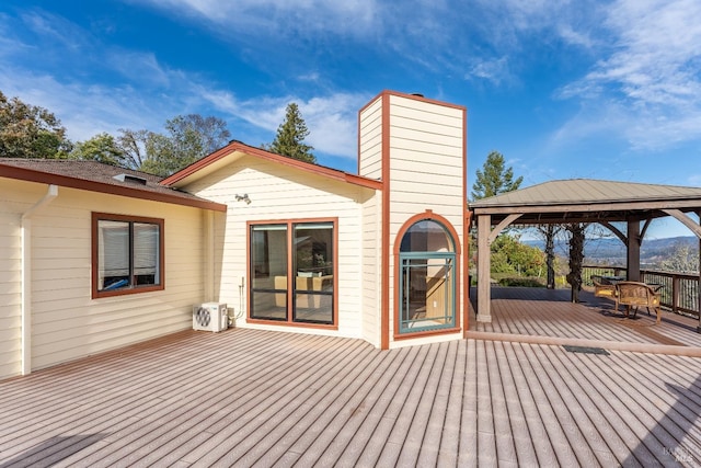 wooden terrace featuring a gazebo