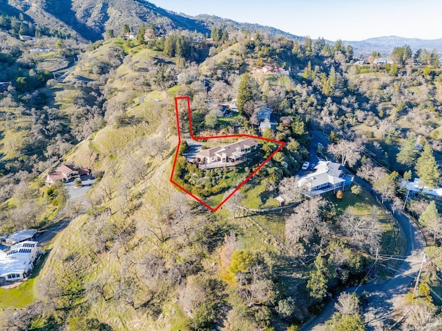 birds eye view of property with a mountain view