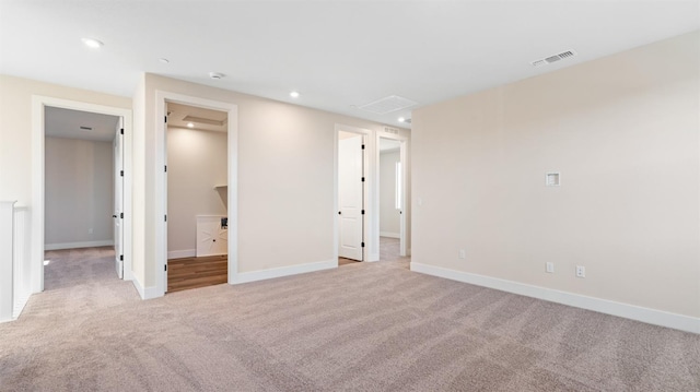 interior space featuring visible vents, baseboards, ensuite bath, carpet, and recessed lighting