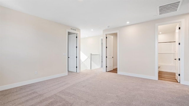 unfurnished bedroom featuring baseboards, visible vents, and carpet flooring