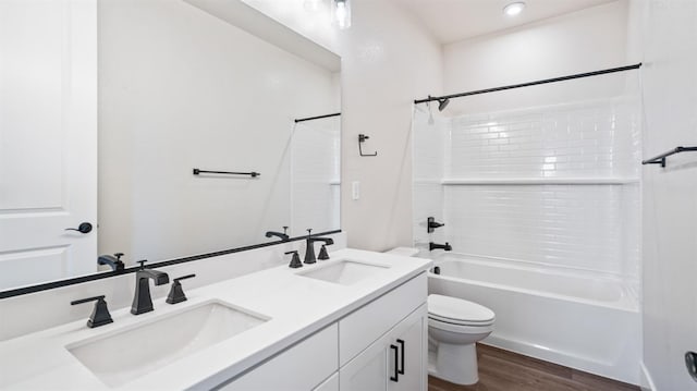 full bathroom with shower / bath combination, a sink, toilet, and wood finished floors