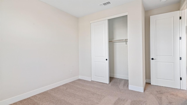 unfurnished bedroom with carpet, visible vents, and baseboards