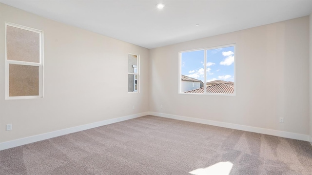 empty room with carpet flooring and baseboards