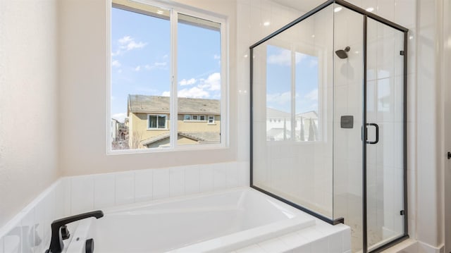 bathroom with a garden tub and a shower stall