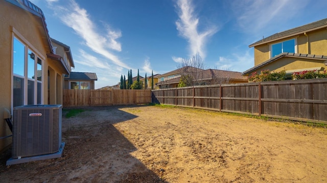 view of yard with cooling unit and a fenced backyard