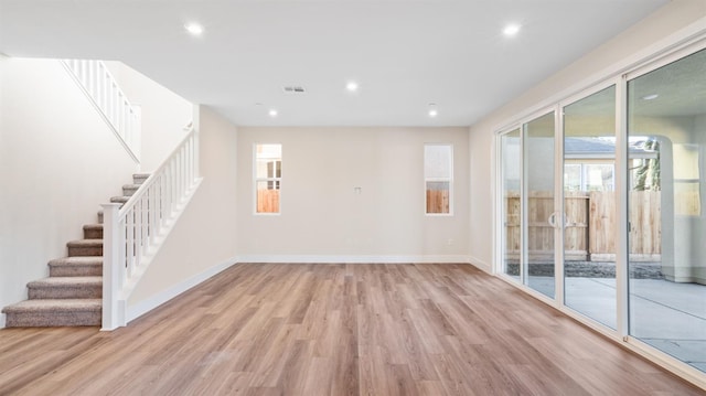 empty room with recessed lighting, light wood-type flooring, visible vents, and baseboards