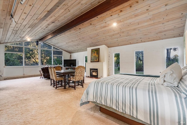 carpeted bedroom with baseboard heating, lofted ceiling with beams, and wood ceiling