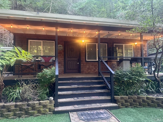 view of exterior entry with covered porch