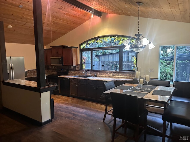 interior space with lofted ceiling, baseboards, a ceiling fan, and wood finished floors