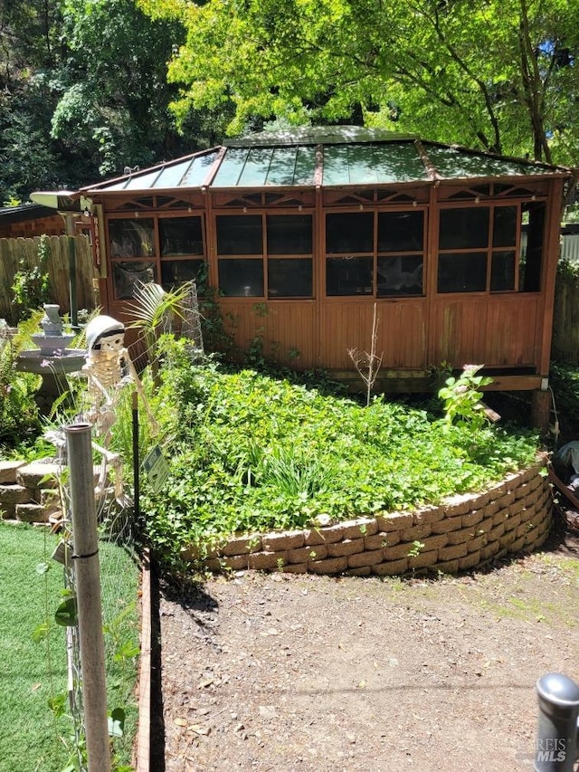 view of yard featuring an outdoor structure and fence