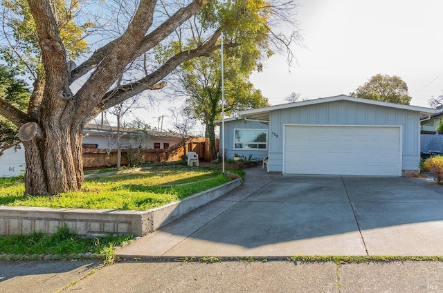 ranch-style home with a garage and a front yard