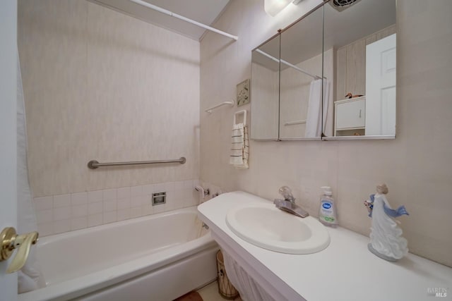 bathroom with bathing tub / shower combination and sink